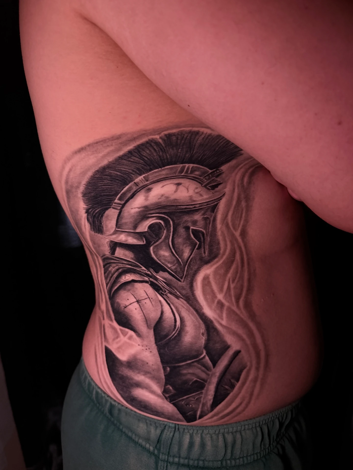 Tatuaje en costado de guerrero espartano realista black and grey realizado por Santana Art